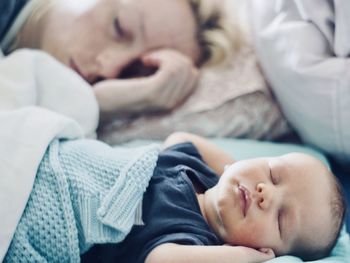 High angle view of boy sleeping on bed