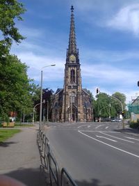 Church on street against blue sky