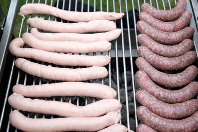 High angle view of sausages on barbeque grill