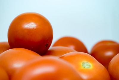 Close-up of oranges over white background