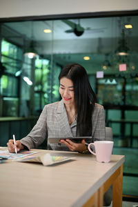 Smiling woman using laptop at table