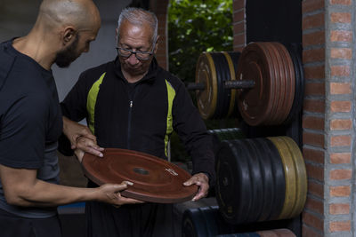 Midsection of man exercising in gym