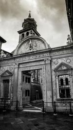 Low angle view of church against cloudy sky