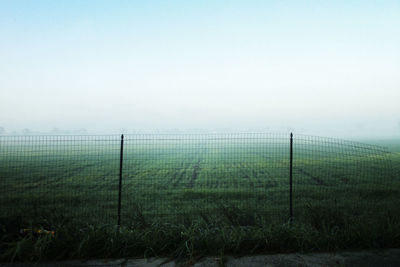 Barbed wire fence in foggy weather