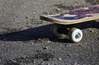 Close-up of skateboard on road