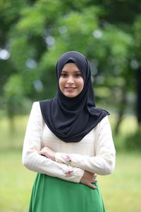 Portrait of smiling young woman in park