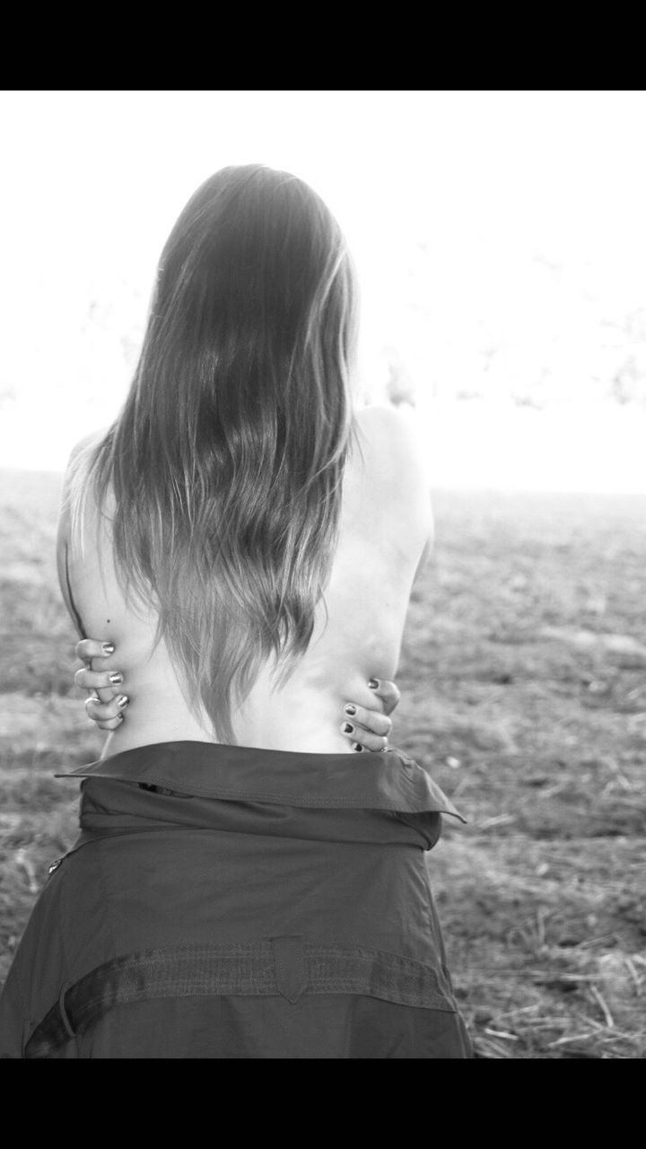 REAR VIEW OF A GIRL LOOKING AT CAMERA