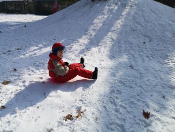 Cheerful boy enjoying on snow field