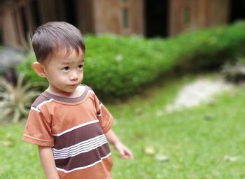 Portrait of cute boy standing outdoors