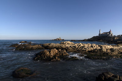 Scenic view of sea against clear blue sky