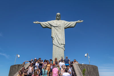 Low angle view of statue against clear blue sky