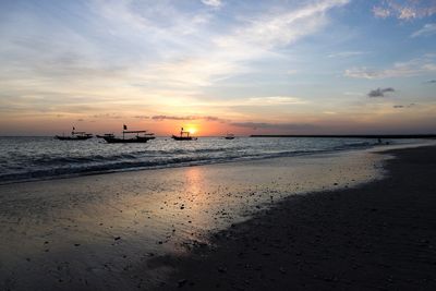 Scenic view of beach against sky during sunset