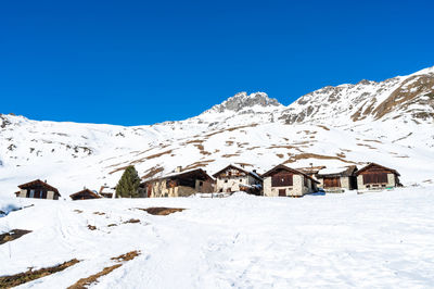 View of the village of grevasalvas, and lake sils, in engadine, switzerland, in winter.