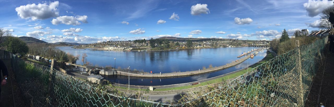 water, sky, panoramic, cloud - sky, river, built structure, tree, cloud, building exterior, nature, blue, sea, architecture, city, tranquility, scenics, transportation, high angle view, day, beauty in nature