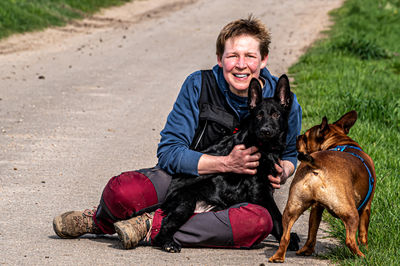 Portrait of man with dog on field