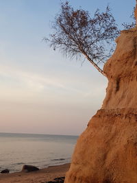 Scenic view of beach against sky during sunset