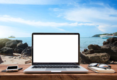 High angle view of laptop on beach