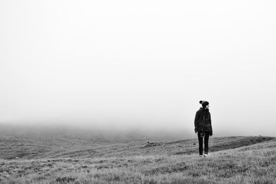 Rear view of man standing in forest