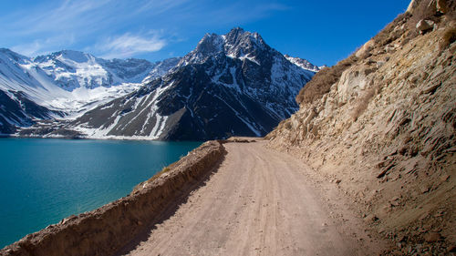 Panoramic view of snowcapped mountains against blue sky