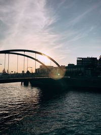 Bridge over river during sunset