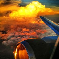 Cropped image of train against cloudy sky at sunset