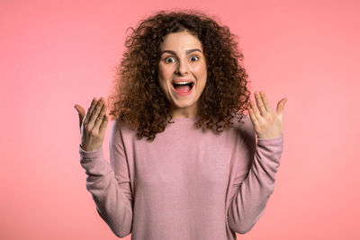 Portrait of woman against red background