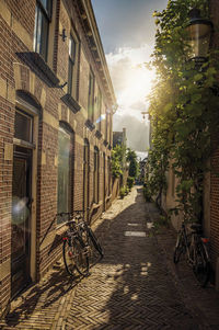 Alleyway with brick houses and bikes at sunset in weesp. a pleasant small village in netherlands.