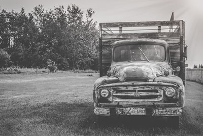 Vintage car on field against sky