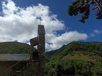 Low angle view of building against cloudy sky