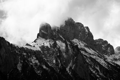 Low angle view of rocky mountains against sky