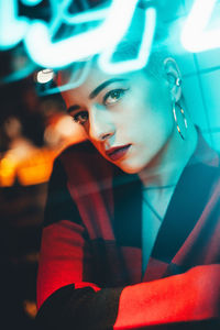 Close-up portrait of young woman sitting in restaurant