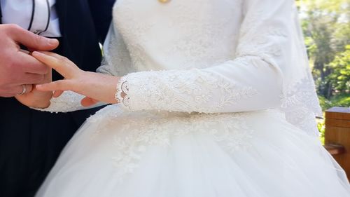 Midsection of woman holding bouquet