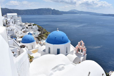 Panoramic view of sea against sky. blue dome in oia, santorini, greece 