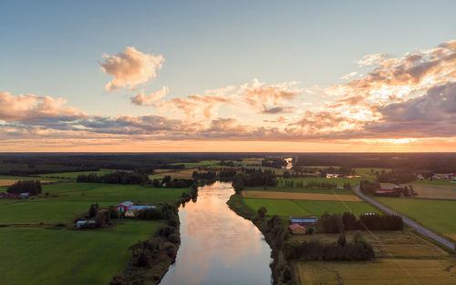 Scenic view of land against sky during sunset