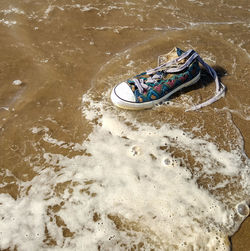 High angle view of canvas shoe at beach