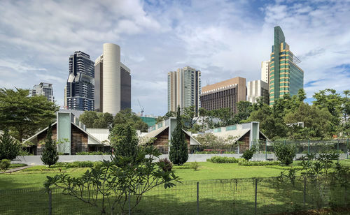 Modern buildings against sky in city