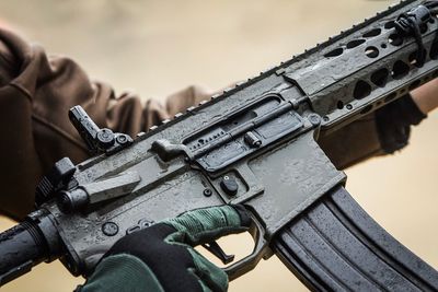 Close-up of person holding gun 