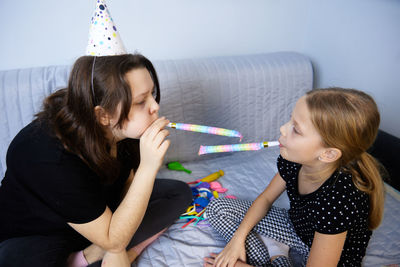 Children have fun playing, blowing up colorful balloons, at a birthday party