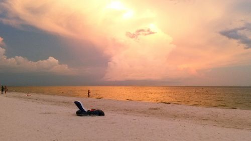 Scenic view of beach against sky during sunset