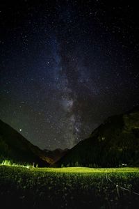 Scenic view of mountains against sky at night