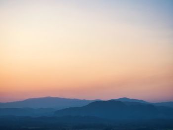 Scenic view of silhouette mountains against sky during sunset