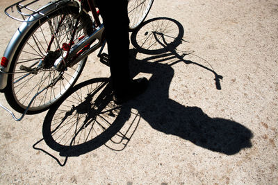 Low section of man with bicycle