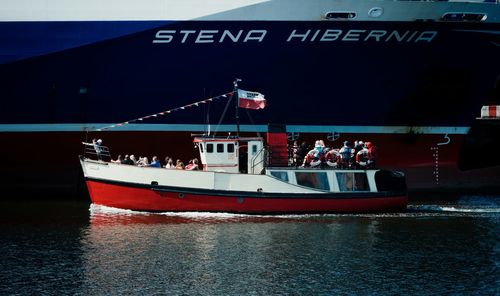 People on boat against sea