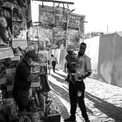 Rear view of people standing on street