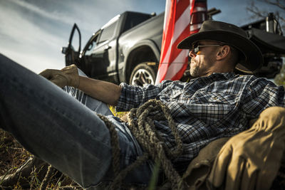 Low section of man sitting in car