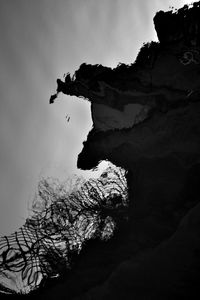 Low angle view of silhouette tree against sky