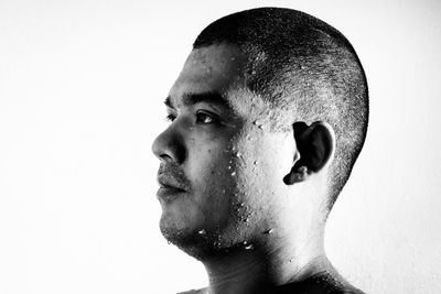 Close-up portrait of young man against white background