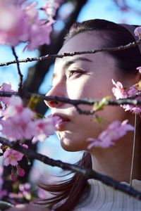 Portrait of woman with red flowering plants