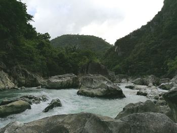 Scenic view of waterfall against sky