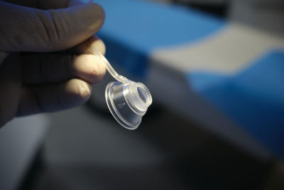 Close-up of hand holding light bulb